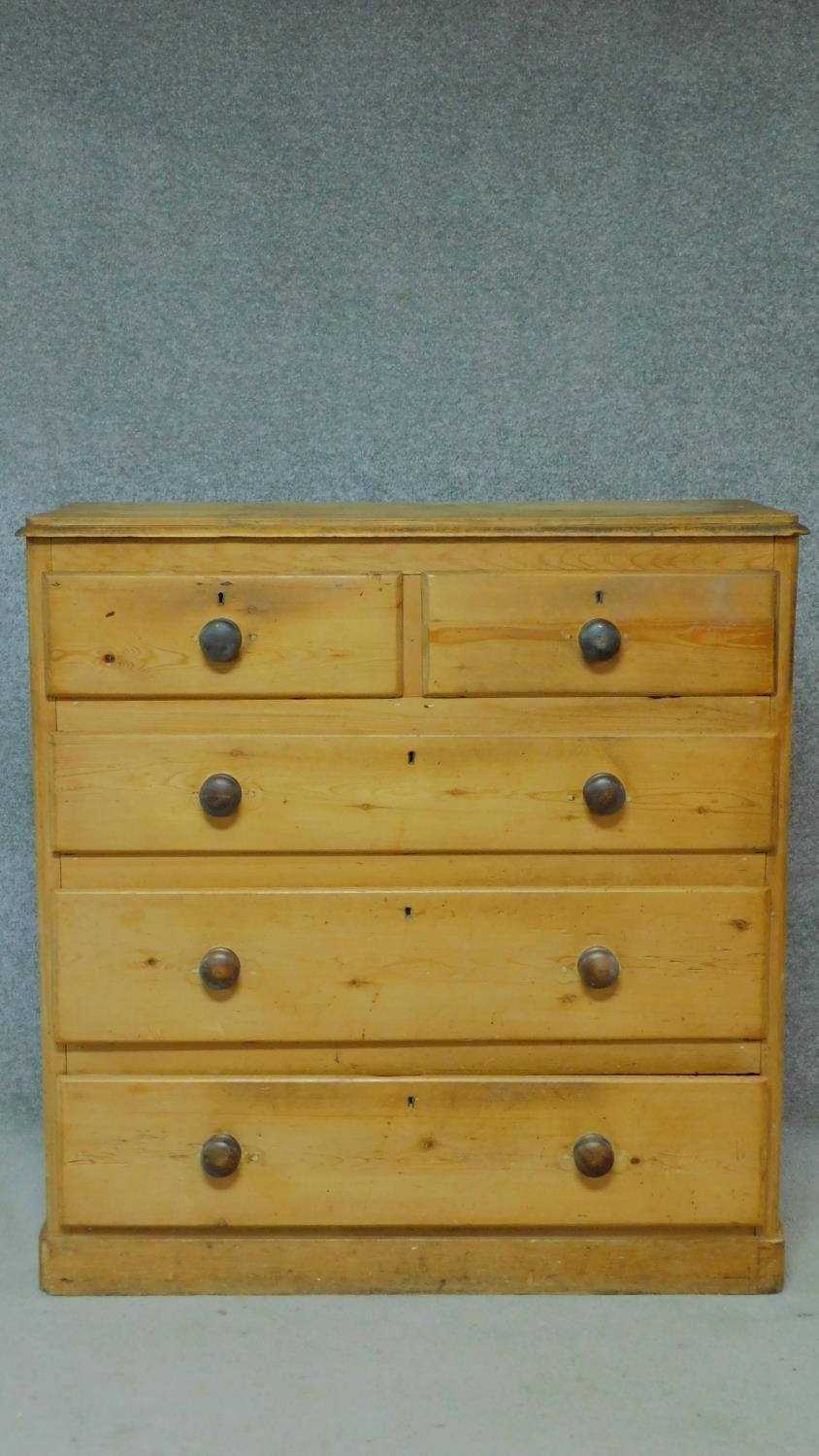 A Victorian pine chest of two short over three long graduated drawers on plinth base, fitted with