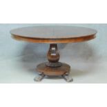 A William IV mahogany tilt top dining table with facetted bulbous pedestal on platform base