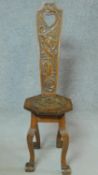A Continental oak spinning chair with allover floral carving on cabriole supports. H.101cm