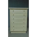 A contemporary white lacquered tallboy with faux bamboo design. H.111 W.80 D.47cm