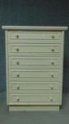 A contemporary white lacquered tallboy with faux bamboo design. H.111 W.80 D.47cm