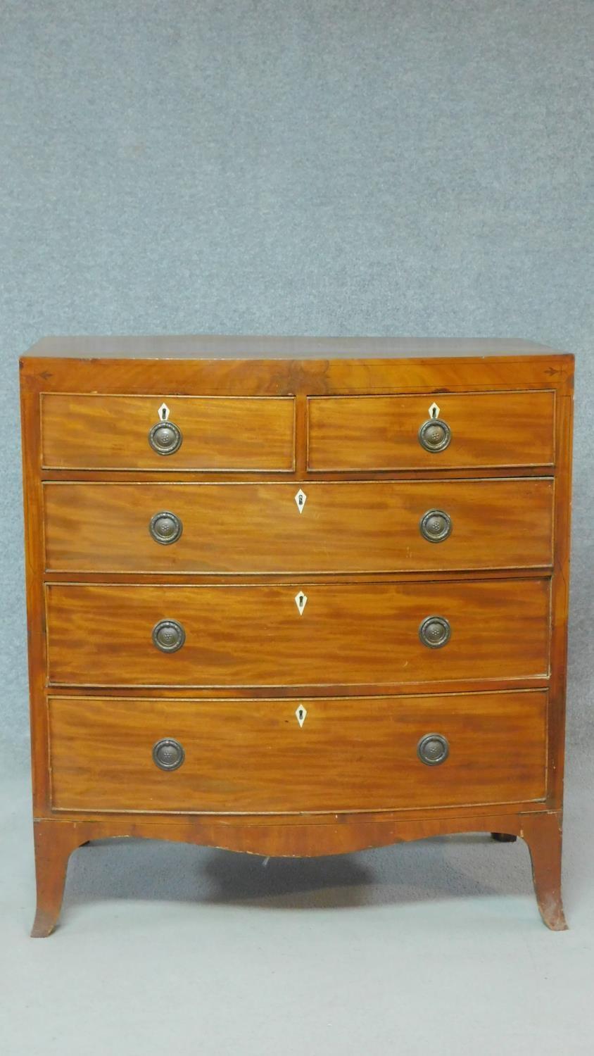 A Regency mahogany bowfronted chest of drawers with ebony inlay to the frieze and with ivory