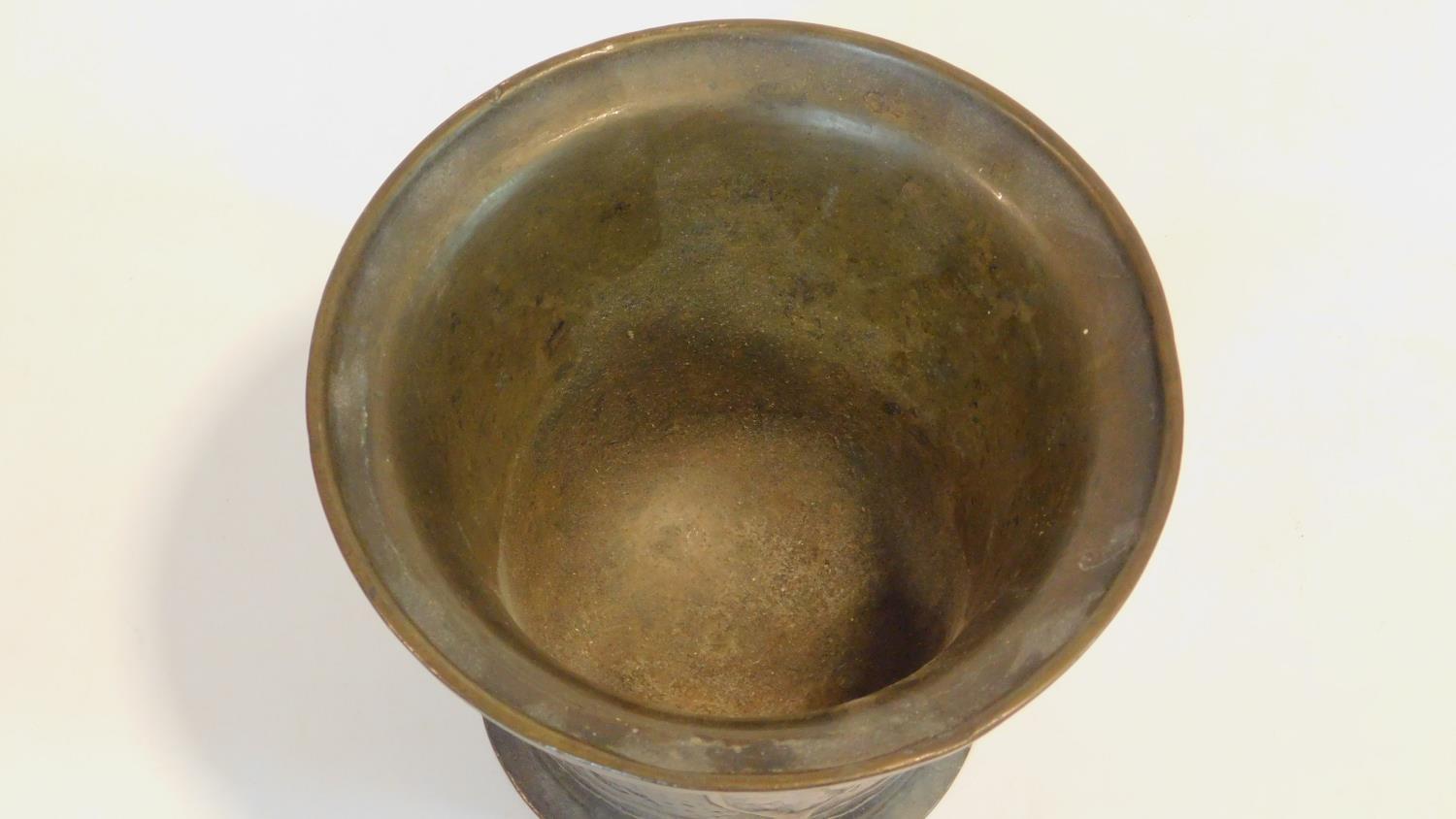 An antique bronze handled mortar and brass pestle. The handle has a textured design and the front of - Image 3 of 8
