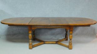 A mid 20th century Ipswich oak extending dining table in the Jacobean style on turned stretchered