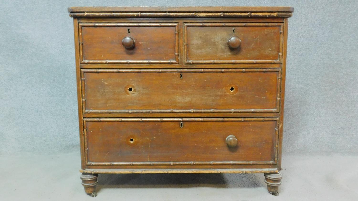 An early 19th century pitch pine chest of drawers with faux bamboo mouldings raised on squat