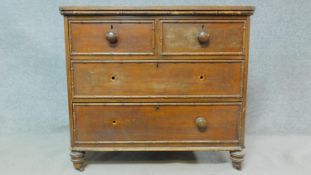 An early 19th century pitch pine chest of drawers with faux bamboo mouldings raised on squat