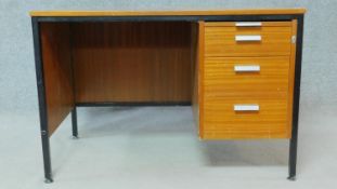 A mid century vintage teak and metal framed desk with a bank of three graduating drawers. H.71 W.107