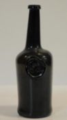 An 18th century All Soul's College common room, Oxford sealed brown glass wine bottle. H.29cm