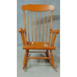 A 19th century style teak framed rocking chair. H.102cm