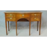 A small Regency mahogany serpentine fronted sideboard with an arrangement of five drawers and fitted