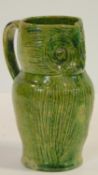 An antique Farnham Pottery type green glaze Harris Owl Jug. H.19cm