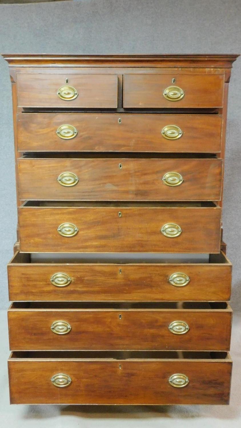 A Georgian mahogany chest on chest with satinwood and ebony inlay and brass plate handles on