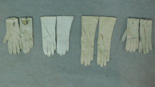 Three pairs of antique kid skin gloves and a pair of leather driving gloves.