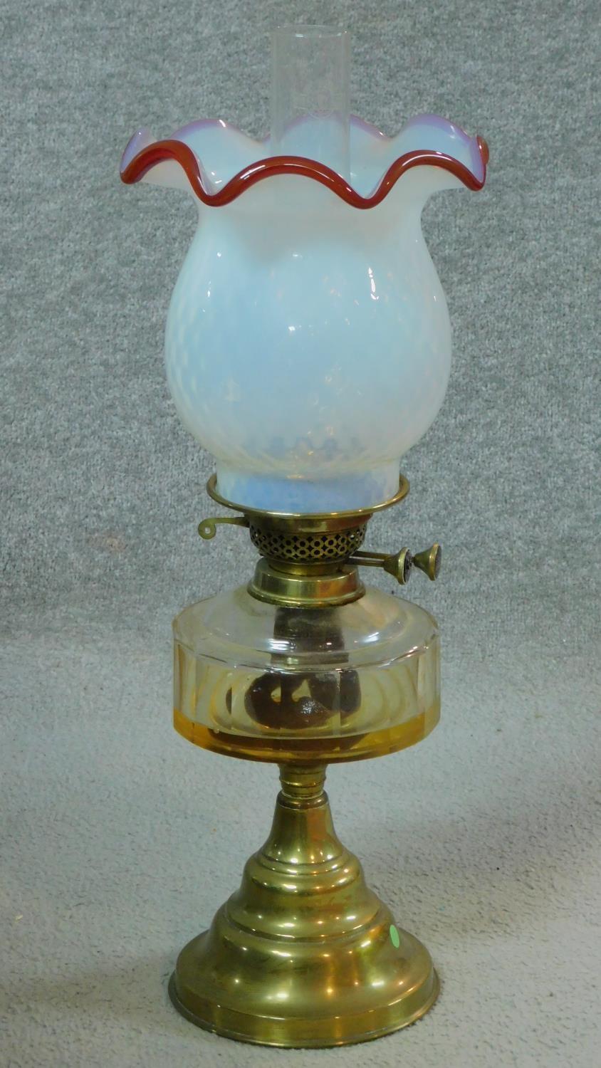 A Victorian opaline white milk glass oil lamp on brass base. (complete) H.55cm