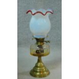 A Victorian opaline white milk glass oil lamp on brass base. (complete) H.55cm