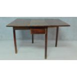 A Georgian mahogany drop flap dining table with gateleg action on square supports. H.72 W.115 D.95cm