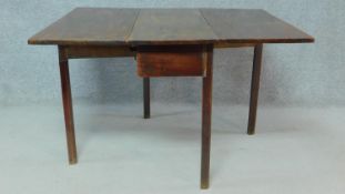 A Georgian mahogany drop flap dining table with gateleg action on square supports. H.72 W.115 D.95cm