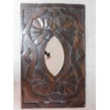 An Eastern teak wall mirror in a large carved lotus leaf and scrolling ribbon frame. 136x84cm