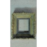 A 19th century carved giltwood and gesso picture frame with ebony slip insert. 25x27cm