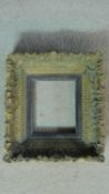 A 19th century carved giltwood and gesso picture frame with ebony slip insert. 25x27cm