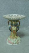 A 19th century style hand painted porcelain comport with four storks as central supports.