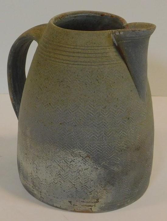 A large studio pottery jug by Chris Lewis, South Heighton Studio with a raised zigzag design. Makers