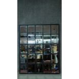 A large wall mirror in painted frame with twenty five individual bevelled plates. 135x110cm