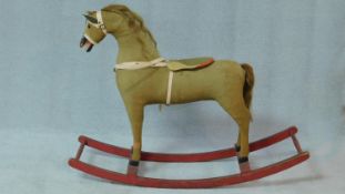 A vintage upholstered rocking horse with horse hair mane and tail. H.82 W.107 D.30cm