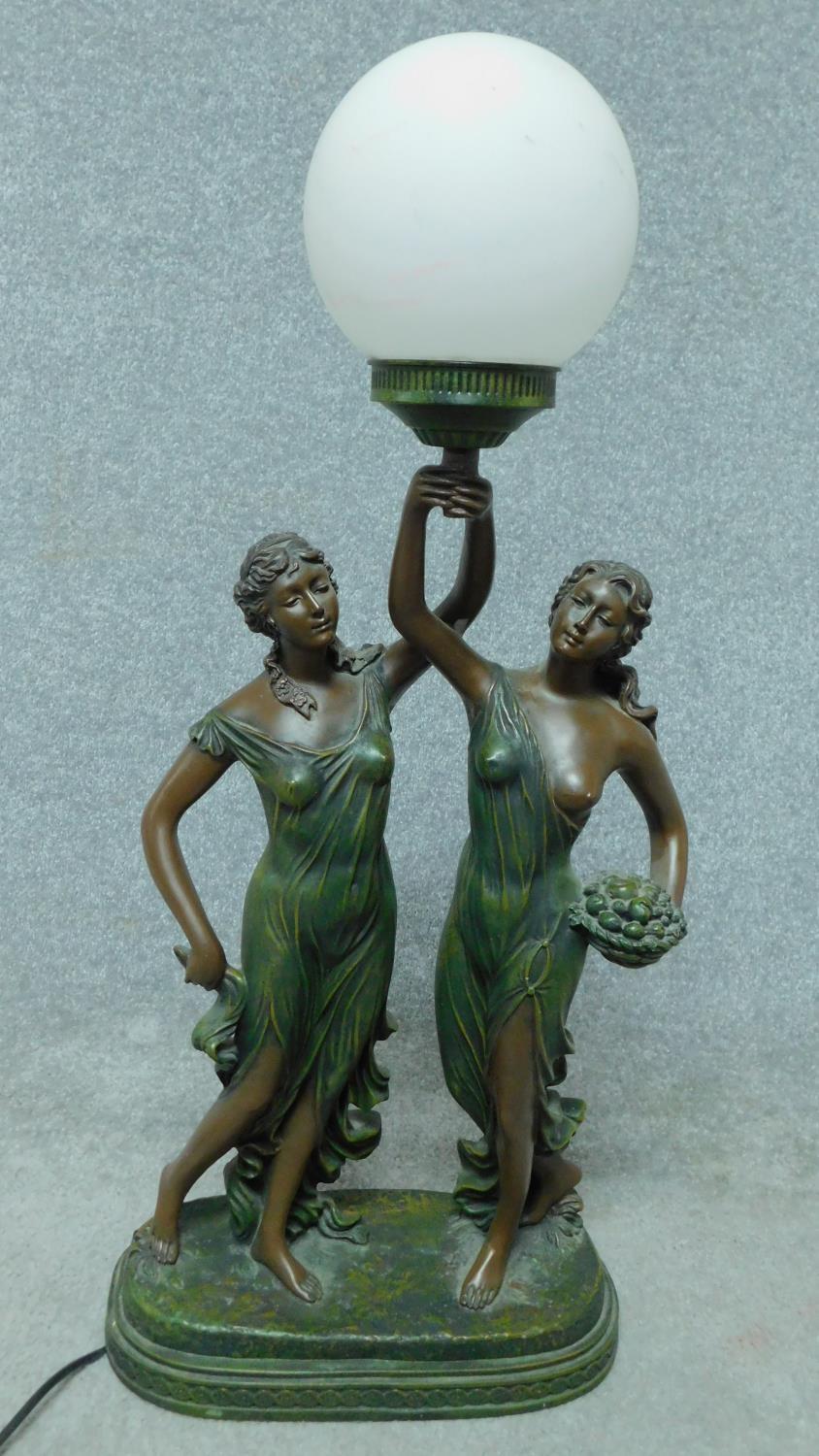 A large spelter figural table lamp, classical maidens holding a globe aloft. H.79cm