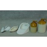 A collection of antique ceramic pieces. Including two glazed stoneware flagons, stamped Liquour