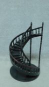 A miniature spiral wooden staircase. H.59 W.34cm