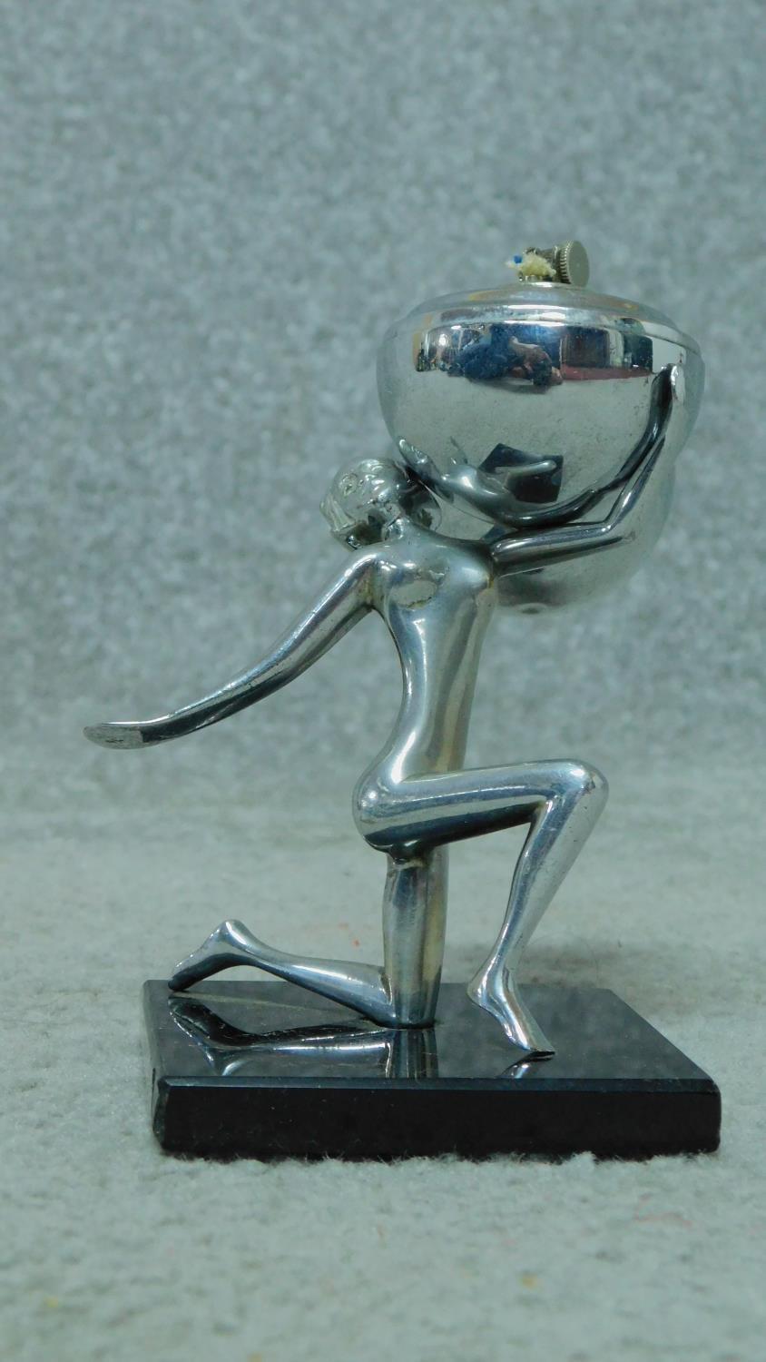 A mid century vintage chromium table lighter in the form of a female rhythmic gymnast and ball. H.