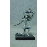 A mid century vintage chromium table lighter in the form of a female rhythmic gymnast and ball. H.