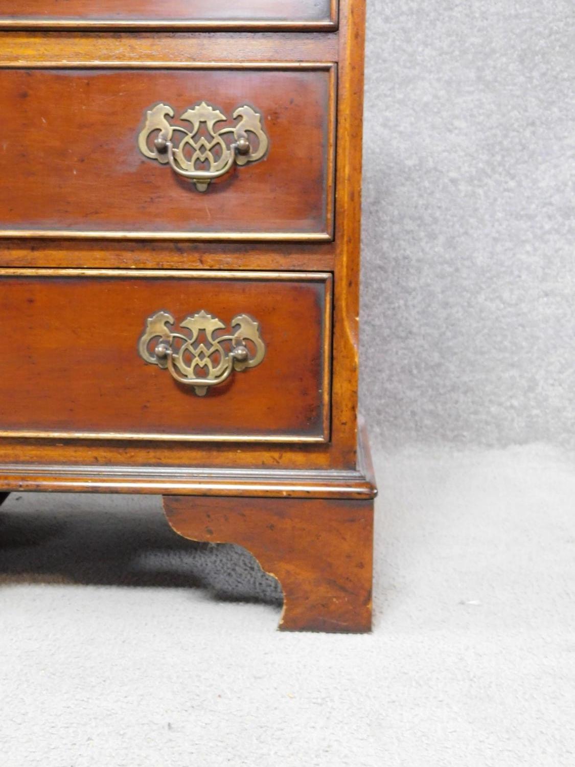 A pair of Georgian style yew wood and crossbanded bedside chests of four drawers on bracket feet. - Image 4 of 4