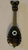 A miniature tortoiseshell mandolin with mother of pearl inlay. W.11cm