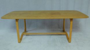 A mid century vintage light elm refectory style dining table on stretchered supports. H.72 W.198 D.
