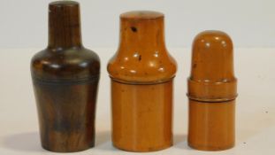 A collection of three treen apothecary's bottle holders with turned screw tops and with their