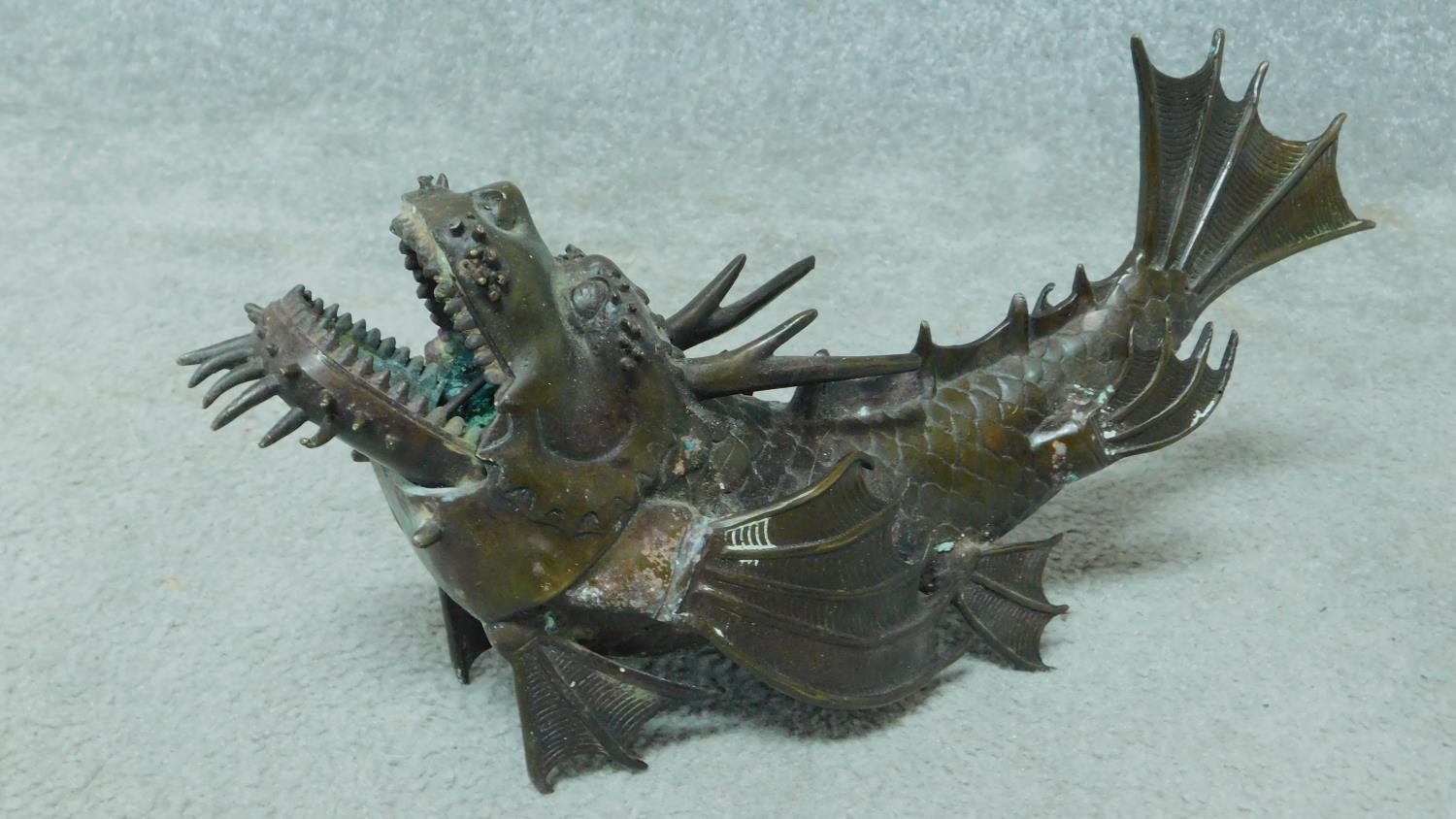 A vintage bronze dragon fish sculpture with engraved detailing. H.16 W.38cm