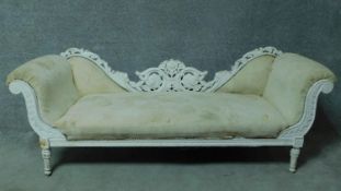 A distressed painted double chair back chaise longue with floral carved frame on turned tapering