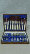 A oak cased six person canteen of silver plated cutlery by Frank Cobb and Co Sheffield. Missing four