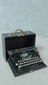A small vintage cased portable typewriter in black carrying case by Underwood. Made in U.S.A. H.13