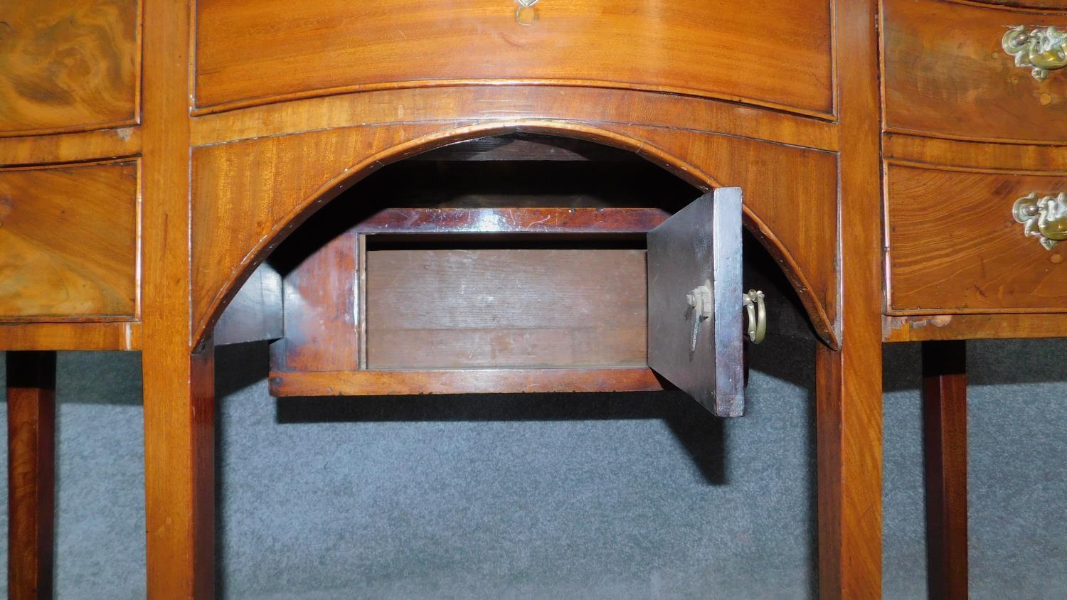 A small Regency mahogany serpentine fronted sideboard with an arrangement of five drawers and fitted - Image 6 of 7