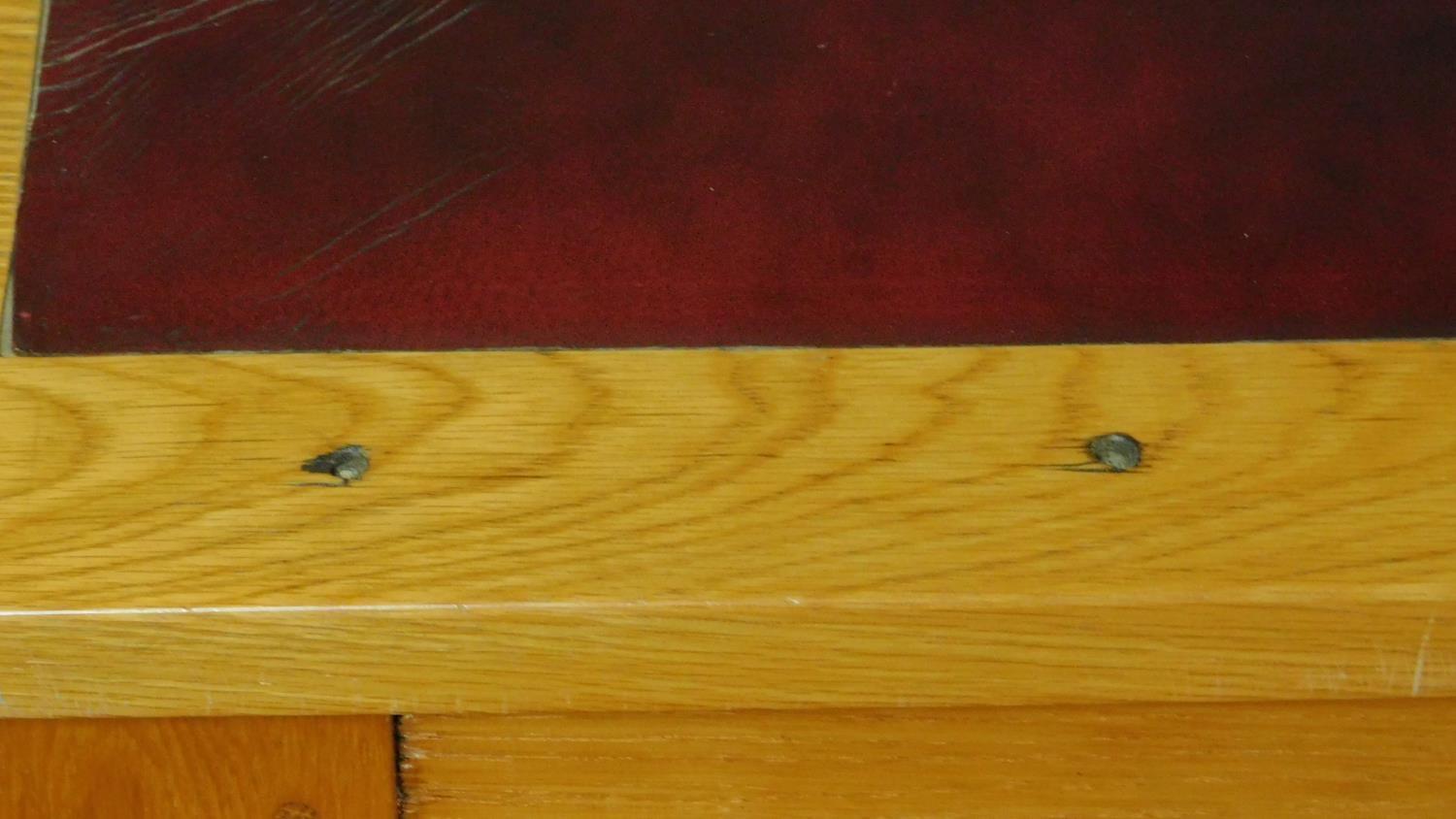 An early 20th Century light oak writing table with maroon tooled leather inset top above opposing - Image 8 of 9