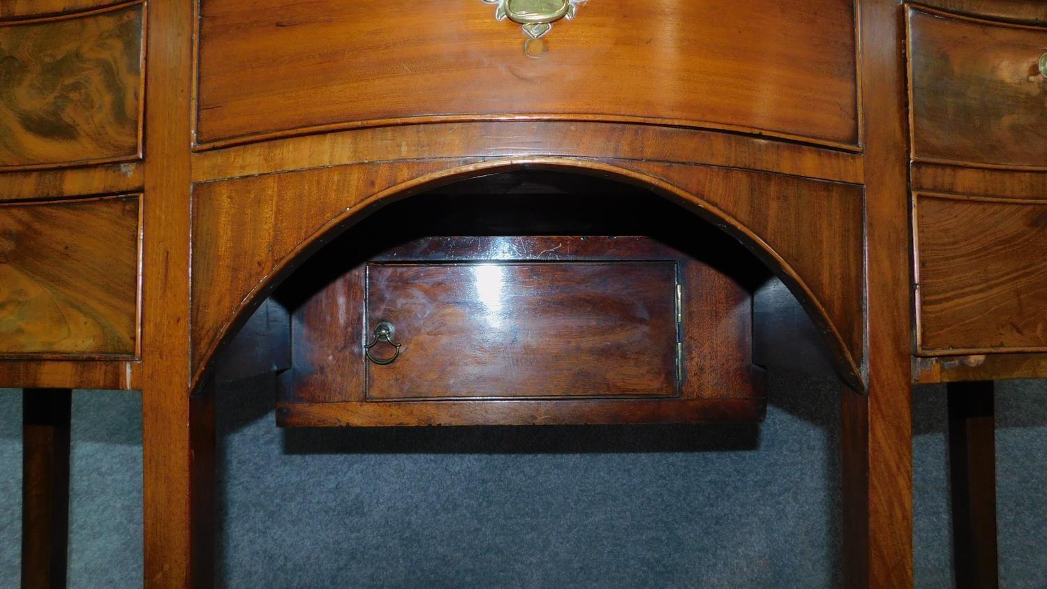 A small Regency mahogany serpentine fronted sideboard with an arrangement of five drawers and fitted - Image 5 of 7