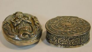 A white metal Indian locket box with Indian deity and snakes along with a repousse scrolling