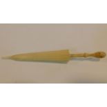 A carved bone stanhope in form of a parasol needle case. With sights from Bournemouth. W.13cm