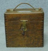 A vintage oak cased West-Skinn of Glastonbury racing pigeon automatic timing clock. With key. H.18