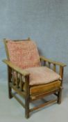 A vintage oak framed armchair with sliding reclining action. H.60 W.110 D.66cm