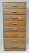 A mid century oak filing chest of eight drawers. H.107 W.53 D.39cm