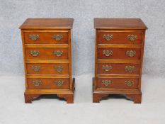 A pair of Georgian style yew wood and crossbanded bedside chests of four drawers on bracket feet.